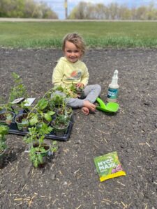 Kids using MycoMaxx Garden on plants